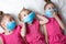 Funny Little children girls in medical masks. Global quarantine at home. Pandemic protection