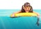 Funny little girl with diving glasses floating inflatable ring,