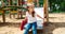 funny little girl on playground. playing child on slide