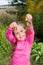 Funny little girl with a sprig of red viburnum