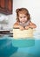 Funny little girl swim in pan in the flooded kitchen, rowdy crea