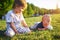 Funny little kids playing with ball on green grass on nature at summer day. Two brothers outdoors. Preschool boy and baby boy. Chi