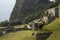 Funny llama urinating in the ruins of the lost city of Machu-Picchu