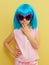 Funny llittle girl in sunglasses and wig