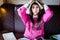 Funny looking brunette woman student trying to study in her room. Funny process of studying for exams