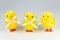 Funny looking Easter chicken toys on grey background