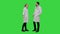 Funny male doctor kidding on female nurse give a false hi five on a Green Screen, Chroma Key.