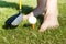 Funny male feets playing with golf ball