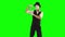 Funny male mime in white and black clothes imitating bodybuilder. One actor performing show on green background