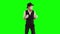 Funny male mime in white and black clothes imitating dancing. One actor performing show on green background. Chromakey
