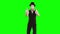 Funny male mime in white and black clothes imitating magician. One actor performing show on green background. Chromakey