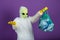 Funny man in an alien mask in a white suit holds a bag with plastic bottles and spreads his arms