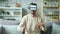 Funny man having fun with ar goggles in apartment moving arms entertaining