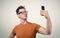 Funny man photographing himself on a smartphone