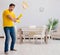 Funny man playing virtual guitar with broom