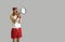 Funny man in sportswear yelling in megaphone standing isolated on grey background