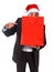 Funny man wearing Santa hat holding red shopping bag