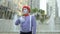 Funny mime in red beret gesticulate hands at fountains background