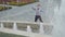 Funny mime touching invisible wall standing near fountains
