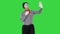 Funny mime in white gloves making selfie photos on a Green Screen, Chroma Key.