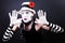 Funny mime in white hat with red flower