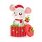 Funny Mouse In Santa Hat Sitting In Red Gift Present Box With Decorations And New Year Balls.