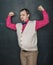 Funny nerd vintage style man flexing his muscle on blackboard