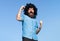 Funny nerdy guy. Crazy funny bearded man with wig on sky background. Expression and success.