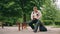 A funny nerdy man is reading book outdoor. A bookworm loser with glasses is preparing to exam.