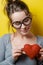 Funny nerdy woman with a red heart on a yellow background. Valen