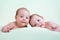 Funny newborn baby twins lying on stomach