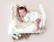 Funny newborn sleeping on tiny bed