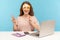 Funny optimistic woman employee covering eyes with bright paper glasses, showing victory gesture and having fun
