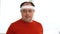 Funny overweight man puts on headband and looking into camera. Caucasian fat man shows his will and confidence in