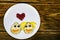 Funny pear couple faces in love with heart shape on a white plate