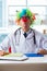 The funny pediatrician with clown wig in the hospital clinic