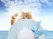 Funny pet cat showing a summer hat in sea and blue sky background, animal holiday concept