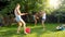 Funny photo of happy family with children playing and splashing water with water guns and garden hose at hot sunny day