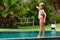 Funny photo of little child relaxing in outdoor swimming pool