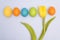 Funny photo of multicoloured Easter eggs against uniform backgr