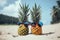 Funny pineapples with sunglasses on the sand beach against turquoise sea