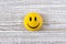 Funny plastic smiley face on a light background. The concept of a positive mood