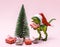 Funny plastic toy dinosaur wearing Santa Claus hat with  present boxes on a pink background