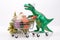 A funny plastic tyrannosaurus rides on a shopping cart full of Christmas gifts