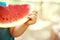 Funny playful boy eating watermelon, seeds on slice