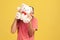 Funny playful man in striped t-shirt having fun hiding behind white fluffy teddy bear, making present, wishing happy holidays