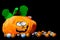 Funny plush toy in the shape of a halloween pumpkin with lots of chocolate balls around it, covered with nice smiley faces