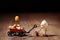 Funny popcorn figure is moving a handcart with a corn figure