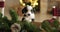 Funny portrait of a cute smiling puppy sitting on a table in a Christmas decorated room