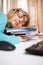 Funny portrait of disheveled young woman sleeping on books